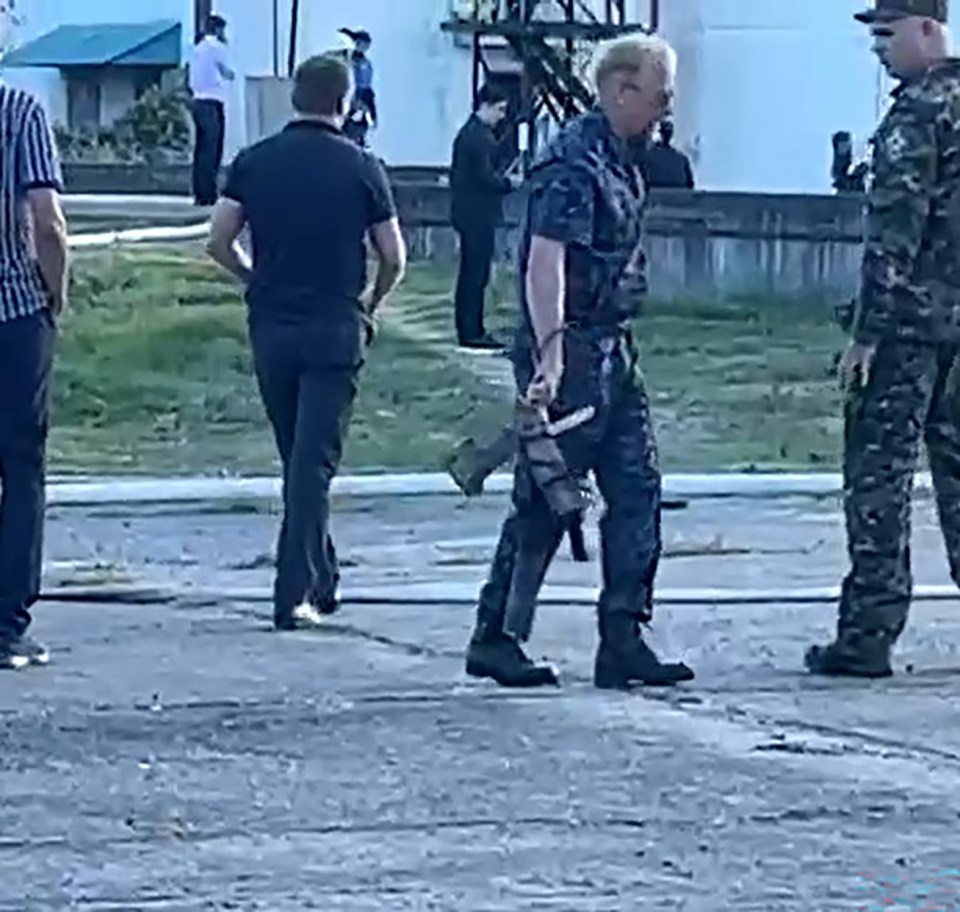 Russian forces carrying away debris of the drone