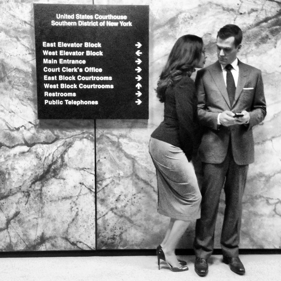 a man and woman standing in front of a sign that says united states courthouse southern district of new york