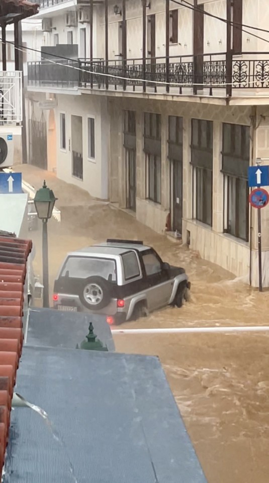 Torrential rain has submerged some cars, with others swept into the sea