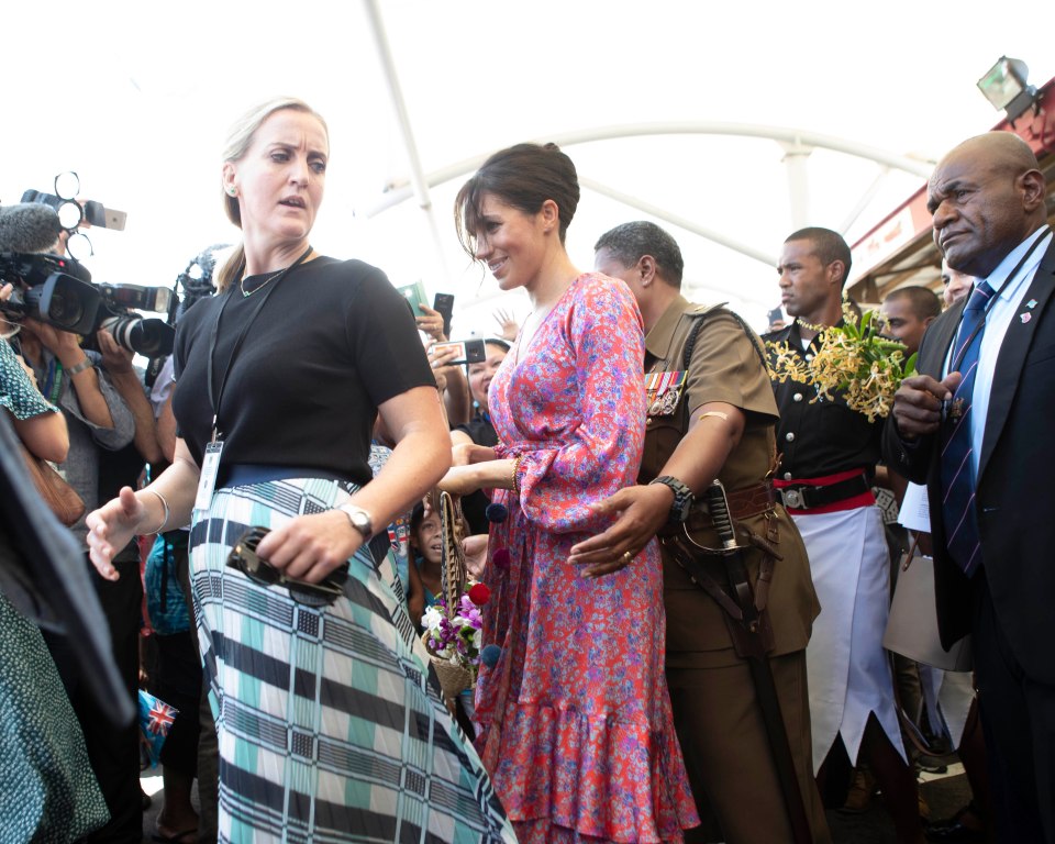 The Duchess of Sussex with her female close protection officer during a visit to Fiji