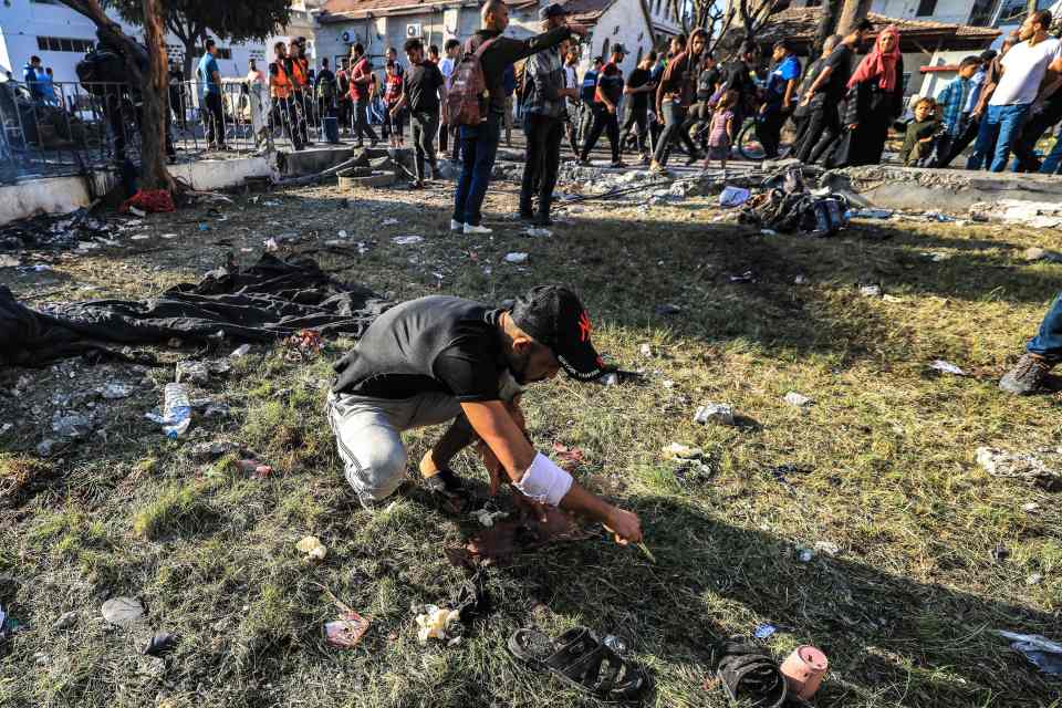 People search through debris outside the site of the Ahli Arab hospital in central Gaza