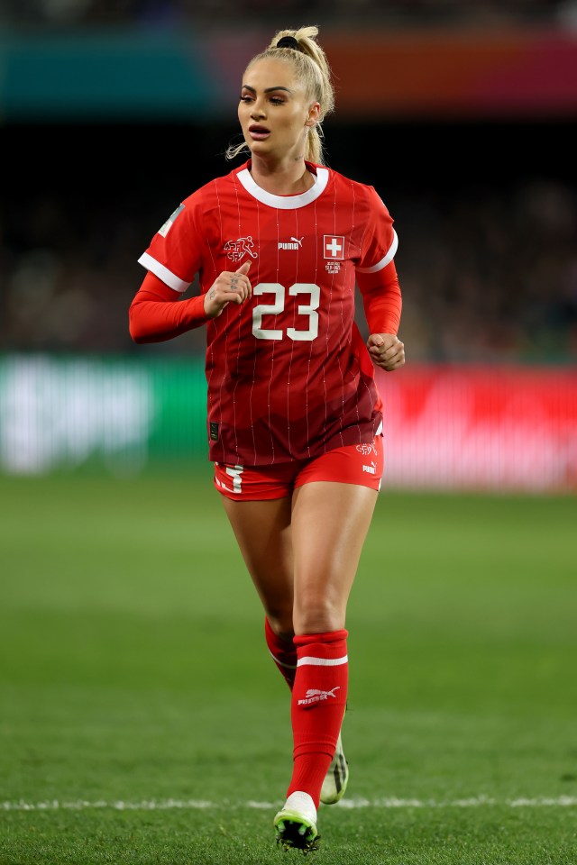 a female soccer player with the number 23 on her jersey