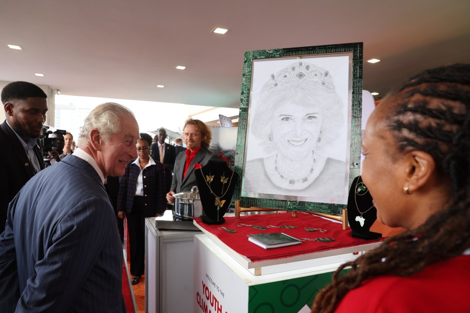 Charles was all smiles when he admired a portrait of Queen Camilla