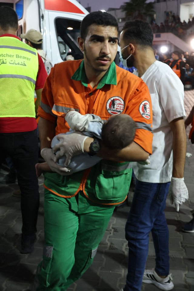 A medic transports an injured Palestinian baby into Al-Shifa hospital in Gaza City following an Israeli airstrike