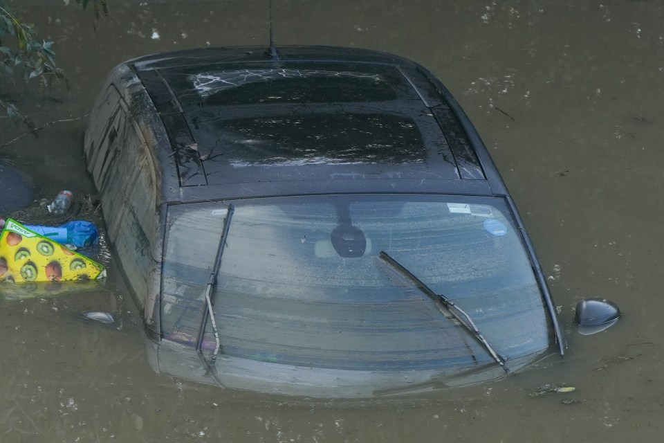 A car is abandoned in flood water in the village of Catcliffe near Sheffield