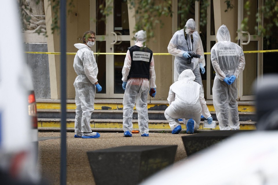 Forensics officers investigate the scene in Arras after the bloodbath