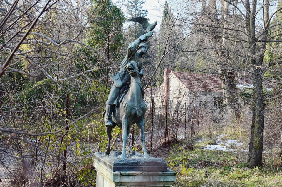 A decaying sculpture of a hunter riding a horse at the summer apalce