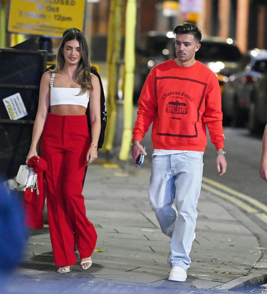 Grealish wore an £800 Gallery Dept red sweatshirt while Sasha had red trousers on