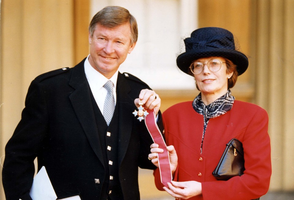 Sir Alex poses with Cathy after receiving a CBE at Buckingham Palace