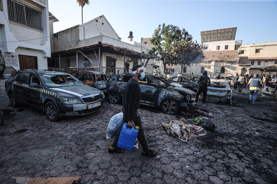 Cars and buildings around the Al-Ahli Arabi Baptist Hospital are destroyed after it was hit in Gaza City on October 18