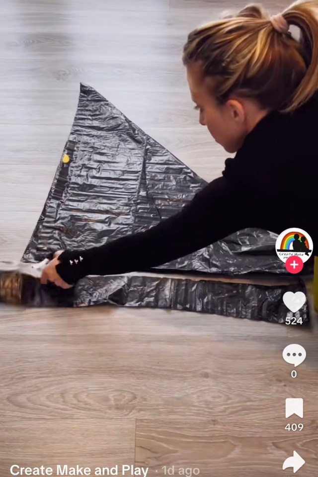 Using scissors to cut bin liner to size. Credit: TikTok/@Create_Make_and_Play