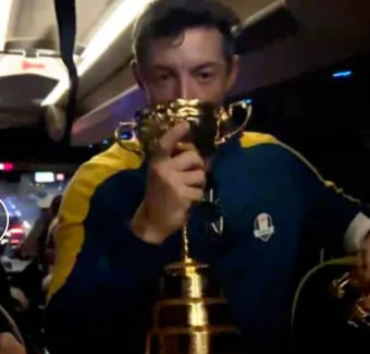 Bleary-eyed Rory McIlroy swigged from the Ryder Cup as Team Europe celebrated their win