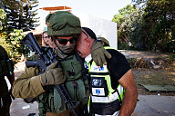 A soldier comforts a man after the bloodbath was discovered