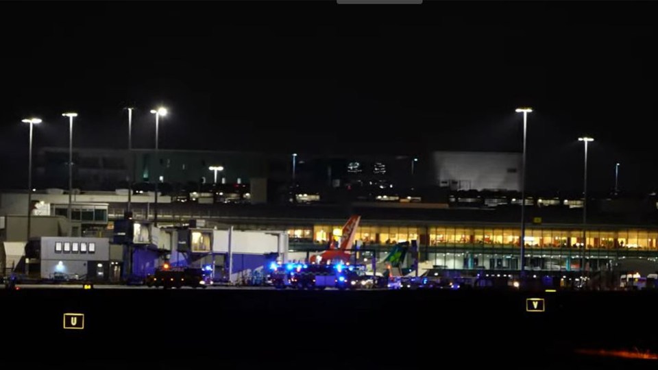 Police and fire crews spotted surrounding an Emirates plane on the runway