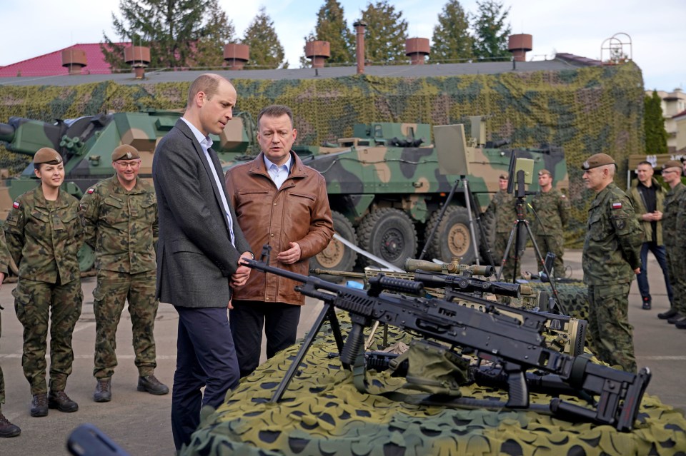 The Prince of Wales viewing military hardware with Polish Deputy Prime Minister and Minister of National Defence, Mariusz Blaszczak, during a visit to the 3rd Brigade Territorial Defence Force base, in Rzeszow, Poland, that has been heavily involved in providing support to Ukraine. Picture date: Wednesday March 22, 2023. PA Photo. Prince William is meeting with the Polish Defence Minister, Mariusz Blaszczak, and speaking to Polish and British troops to learn about the strong companionship they have formed since working together to support Ukraine. See PA story ROYAL William. Photo credit should read: Yui Mok/PA Wire