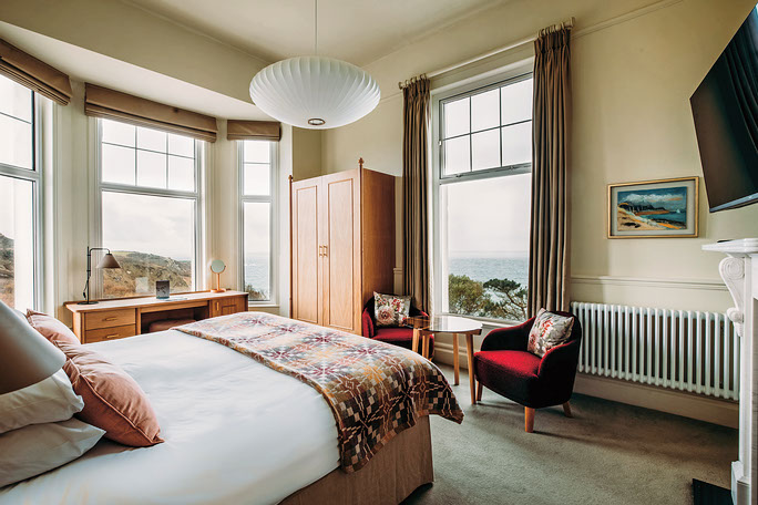 The bedroom is all vintage glamour meets coastal vibes