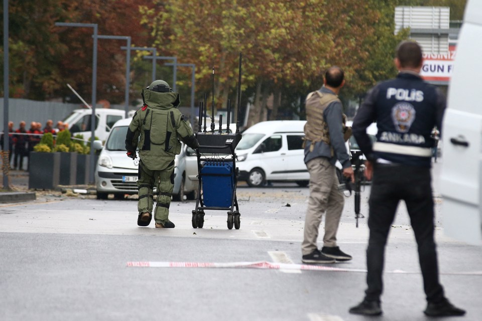 A bomb disposal expert works at the scene after the bomb attack