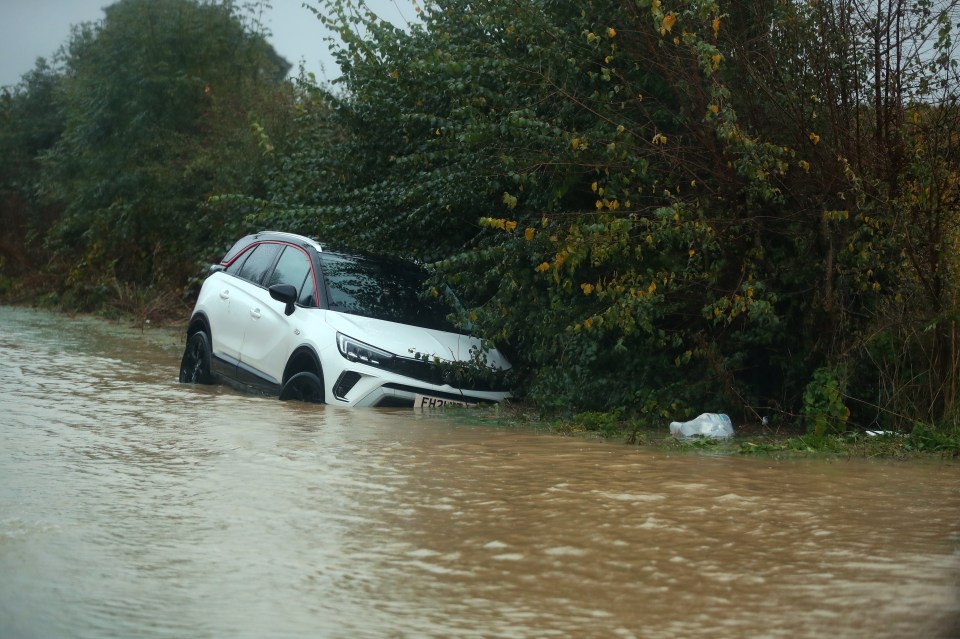 A car is seen stranded in floods in the village of Belton close to Grantham, Lincolnshire