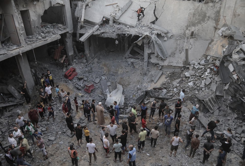 Residents searching for survivors in the rubble following an airstrike, in Khan Younis refugee camp