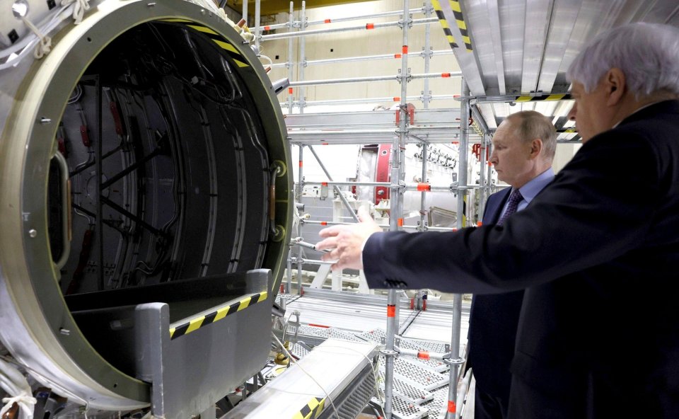 Energia CEO Vladimir Solovyov explains a rocket part to the Russian President