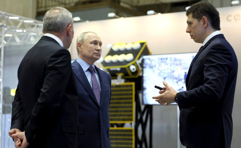 Roscosmos head Yuri Borisov and President Putin listen to an engineer during the tour