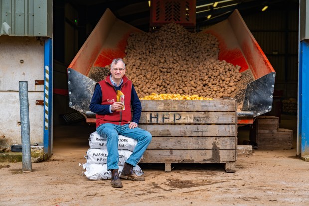 a man sits in front of a crate that says hfp on it