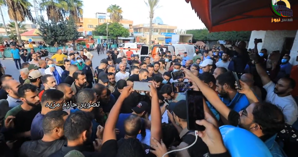 Palestinians carrying Nofal's body after he was killed