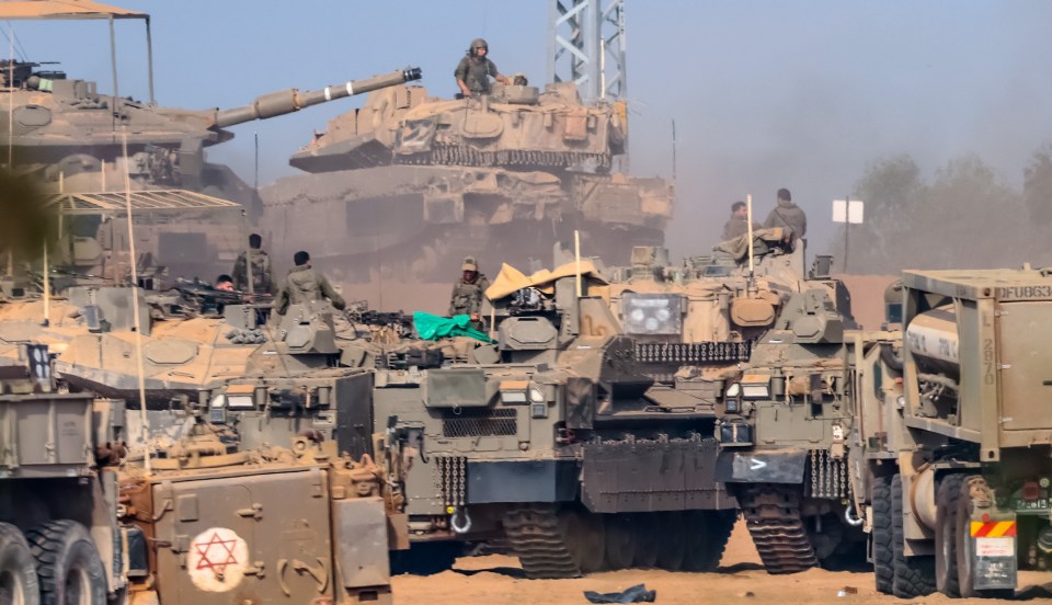 Israeli troops and tanks gather near the border with Gaza