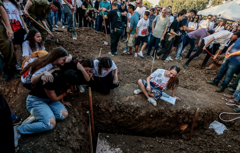 Friends and family members mourn during the funeral of the Sharabis