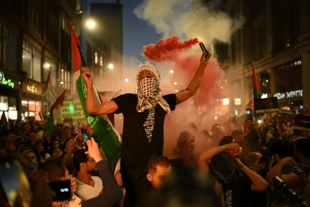 People take part in a ‘Stand with Palestine’ demonstration, close to the Embassy of Israel, in west London