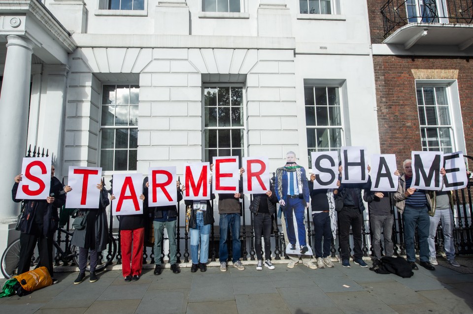 Demonstrators hold banners reading ‘Starmer Shame’