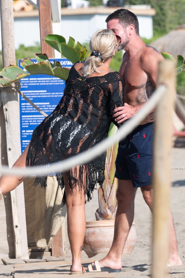 The couple packed on the PDA during the beach outing