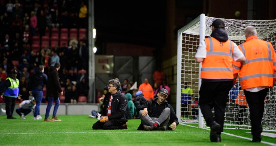 Fans ran onto the pitch in an attempt to stop the game