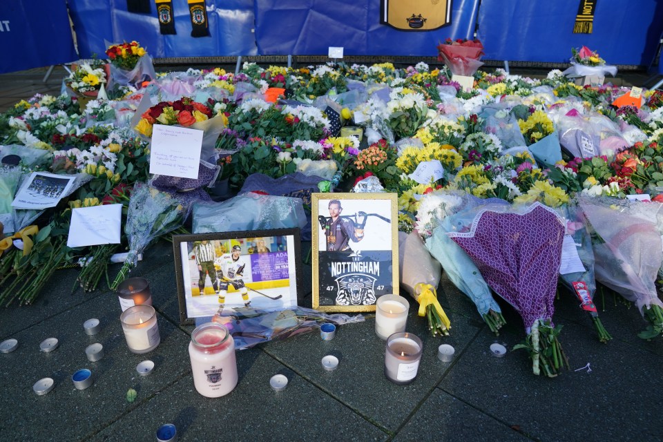 Candles among the flowers and messages left in tribute to Adam Johnson outside the Motorpoint Arena in Nottingham