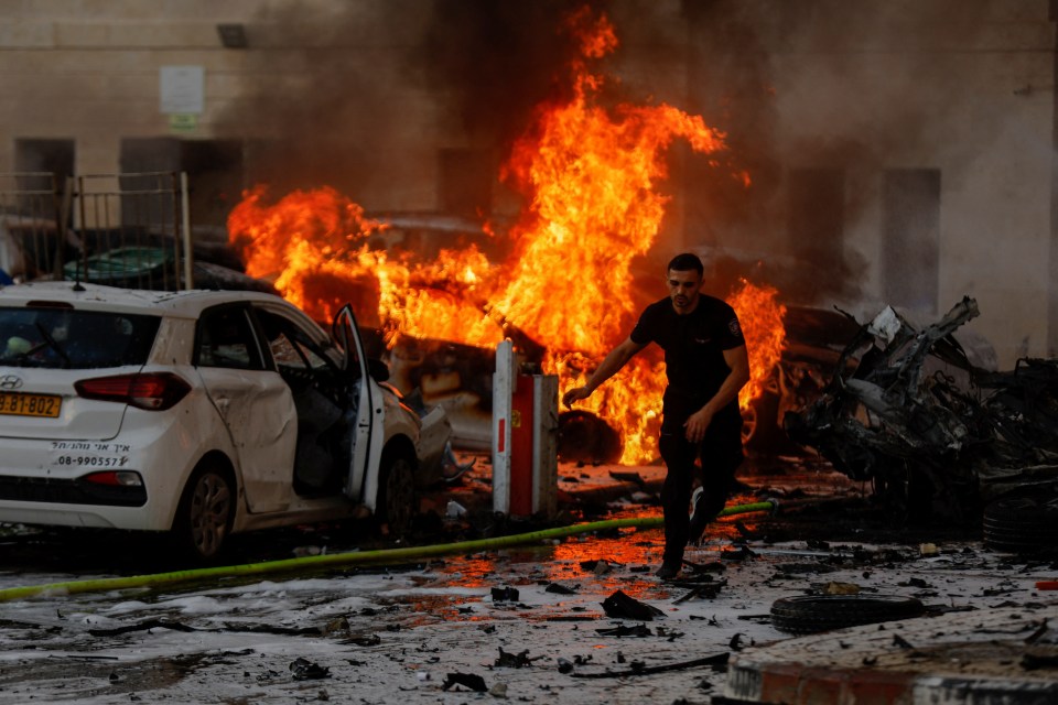 A man runs for cover after a Hamas rocket hit the city of Ashkelon, Israel