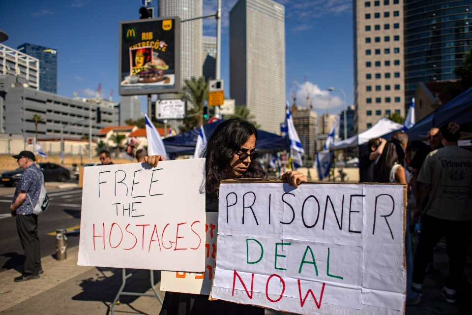 Friends and relatives of hostages held by Hamas militants in Gaza protest outside of the Israeli military base of The Kirya in Tel Aviv