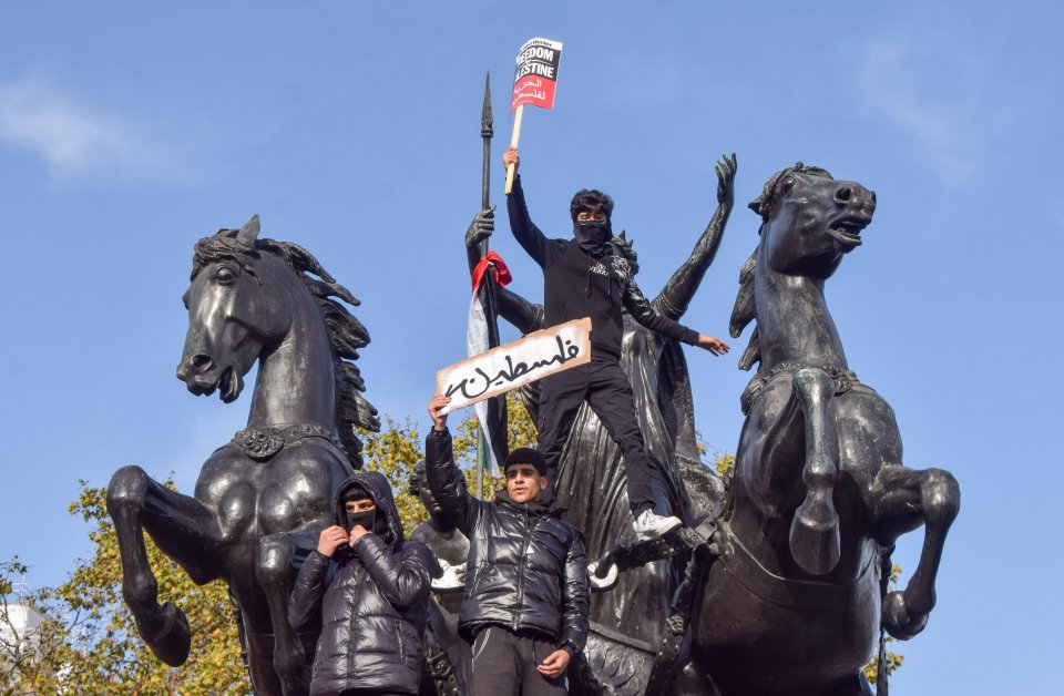 Protestors climbed London monuments under the full gaze of the watching police