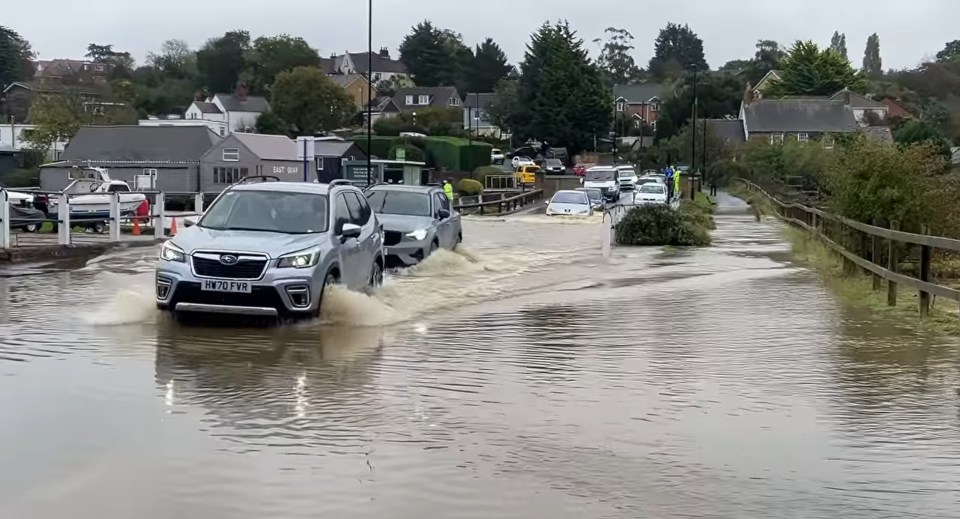 Cars driving through flood water at Wootton Bridge on the Isle of Wight