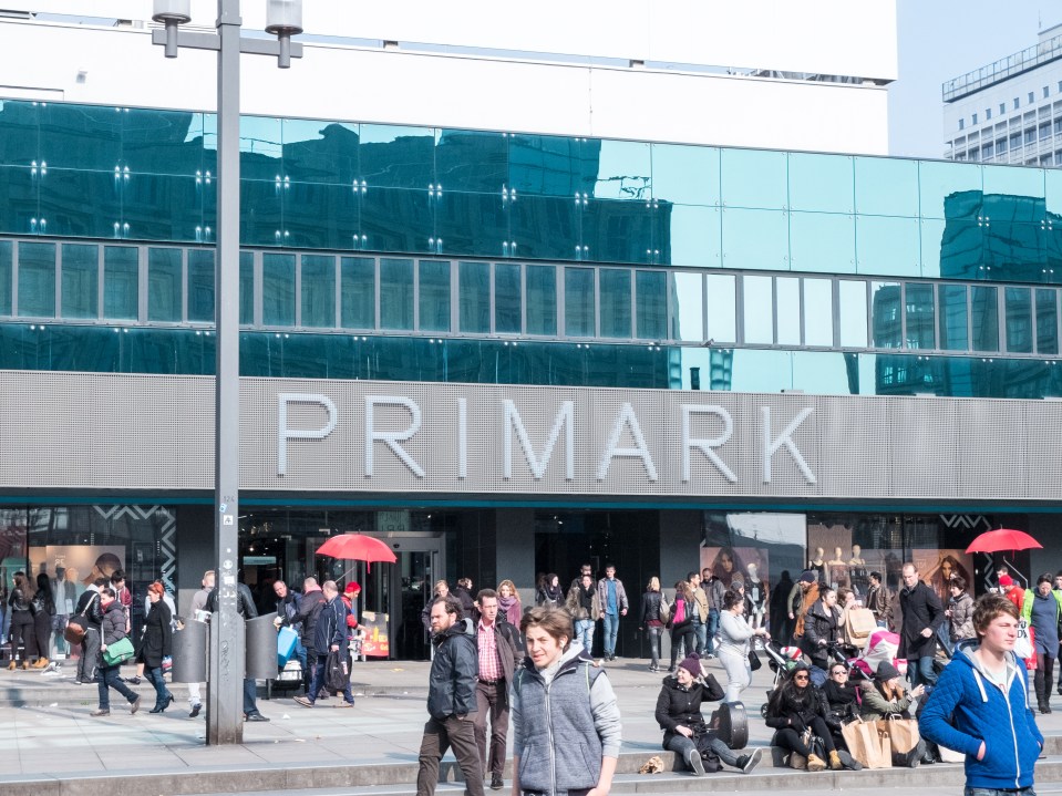 people walking in front of a store called primark