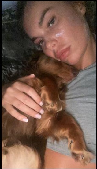 Ashley can be seen hugging her dog in a selfie less than an hour before she died