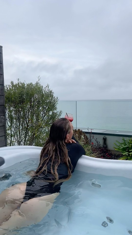 TV star Laura enjoys a drink in a hot tub during the romantic break