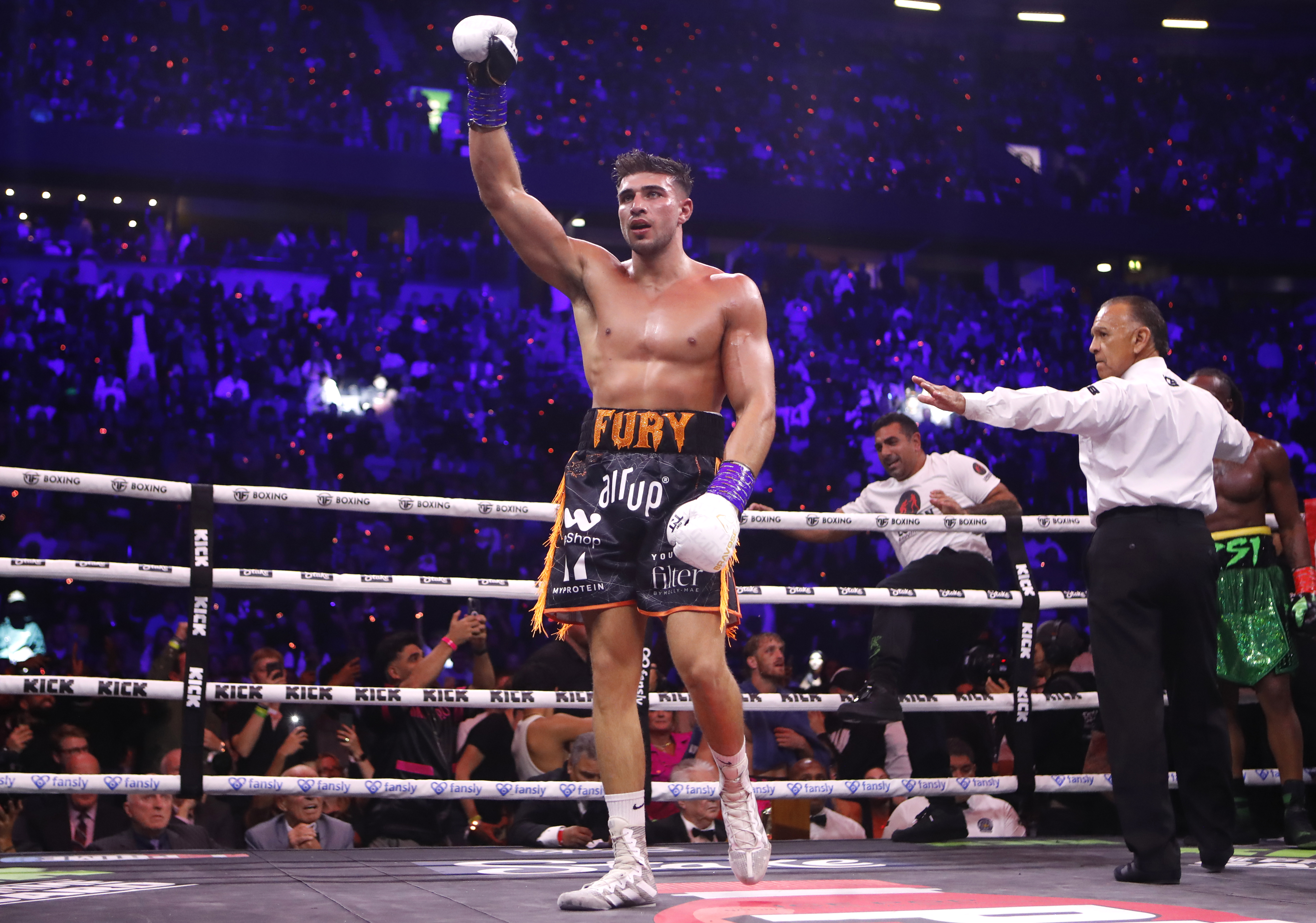 Tommy Fury raises his hand in victory