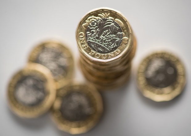 a stack of one pound coins on a table