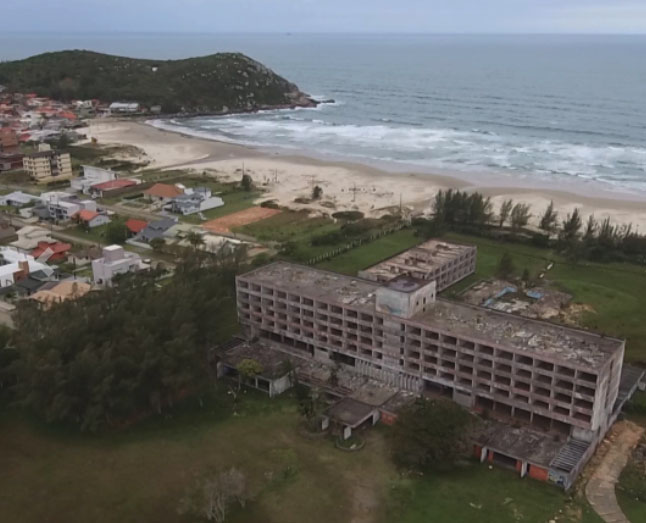 The once-impressive resort now stands empty with 200 hollowed-out rooms, a neglected pool and crumbling walls