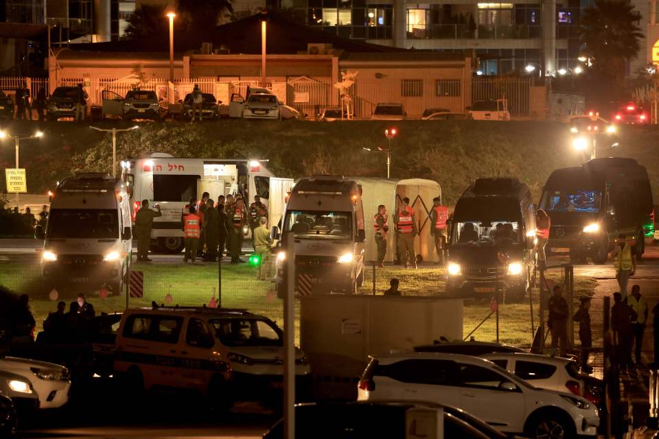 Israeli soldiers wait for the return of young hostages at the helipad of the Schneider Children's Medical Centre in Petah Tikva