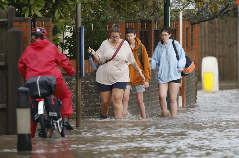 Locals wade through floodwater in Bognor Regis