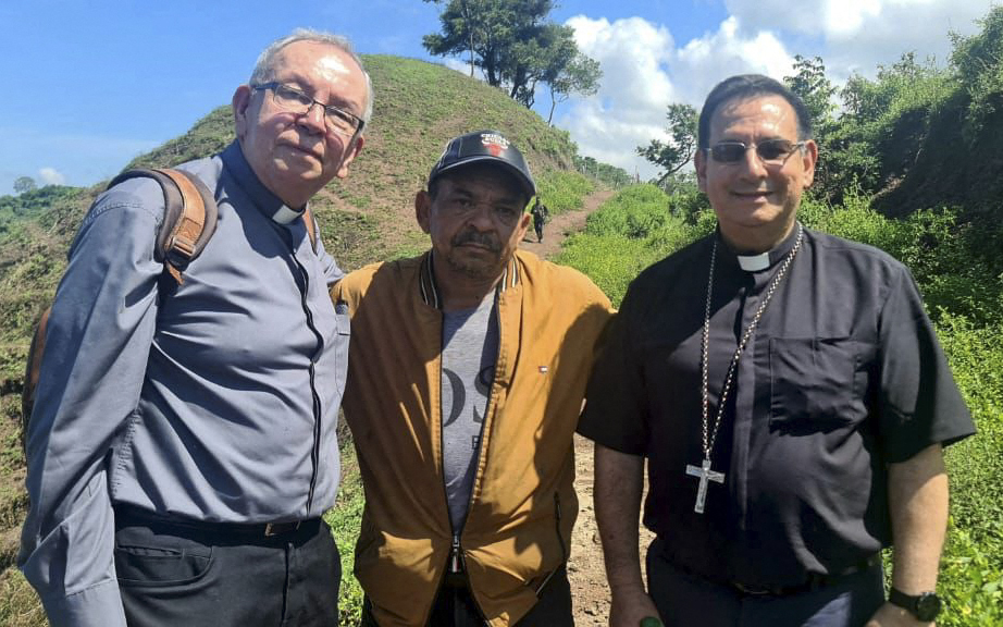 Luis Manuel Diaz, middle, poses with two priests in Colombia following his release