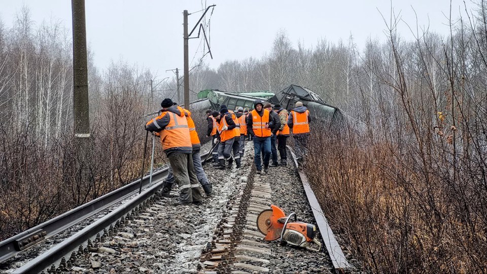 Rail workers attempt to repair the ruined tracks