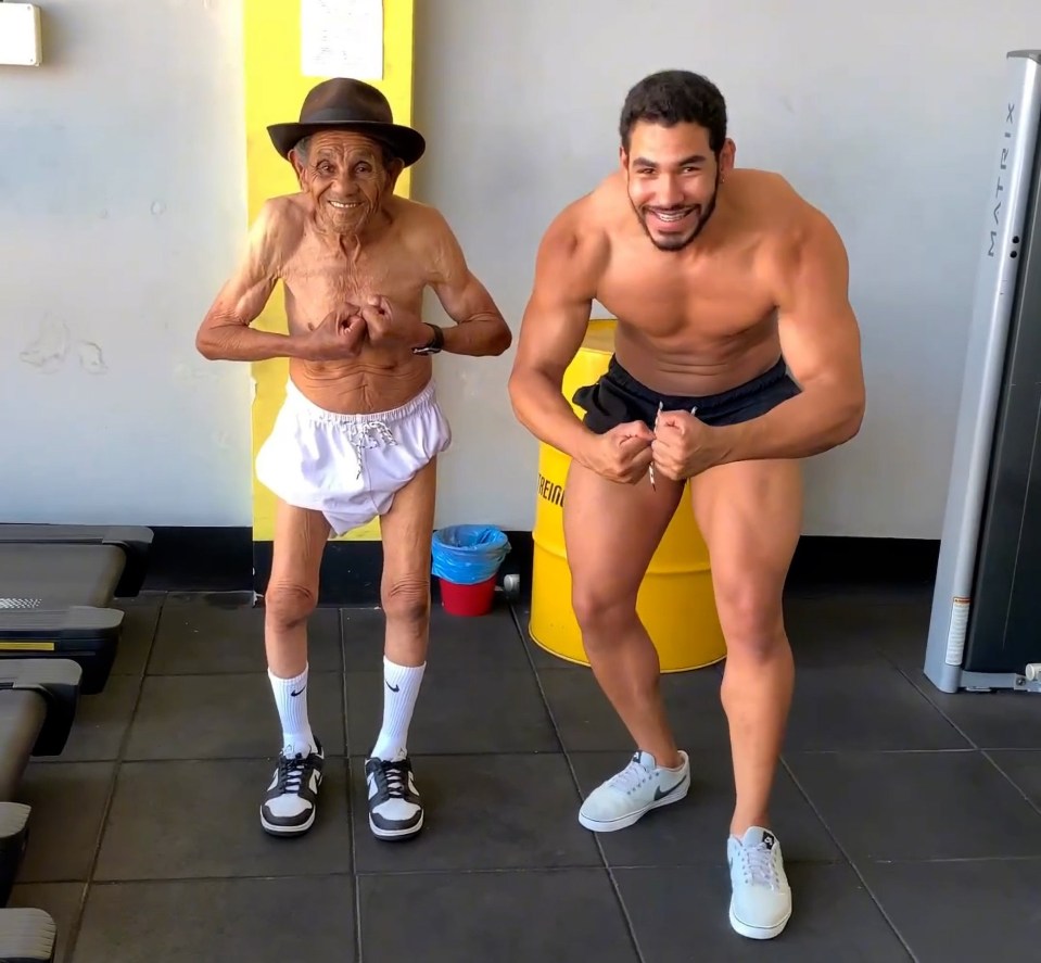 Adivaldino posing with his grandson Matheus Vieira at their gym in Caetite