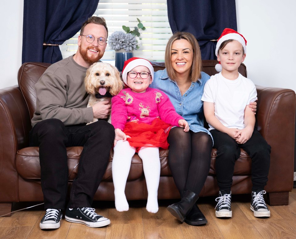 Smiling Florence with her mum Stacey, dad Andy and Freddie